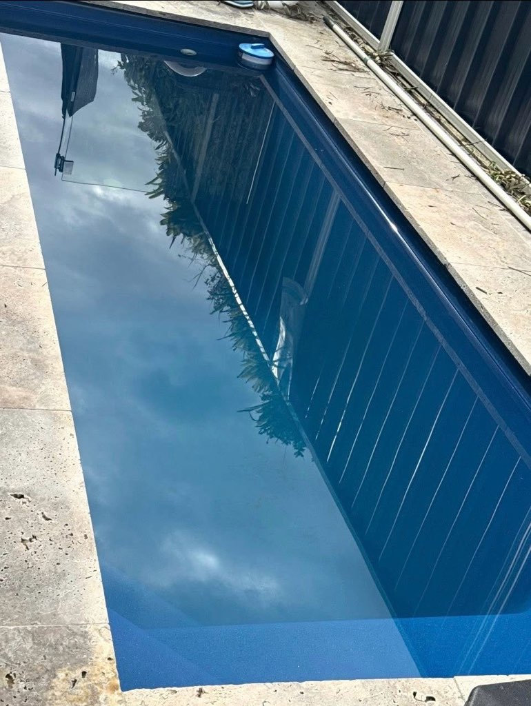 Clean blue pool after debris and algae removal